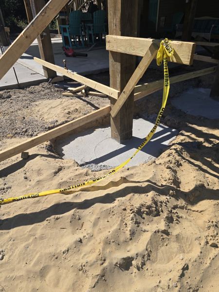 Wood forms and string lines set for footers in sandy soil