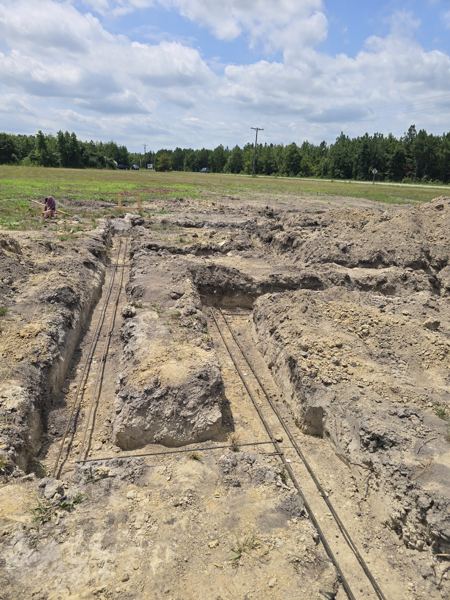 Excavated footer trenches on an open lot