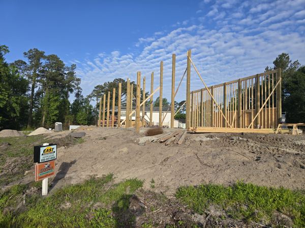 Wall framing going up on a new slab foundation
