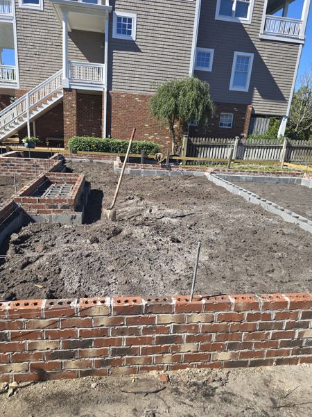 Brick foundation wall with prepared sand fill