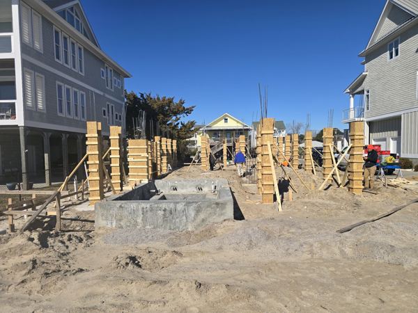 Formed footers and pier forms between raised coastal homes