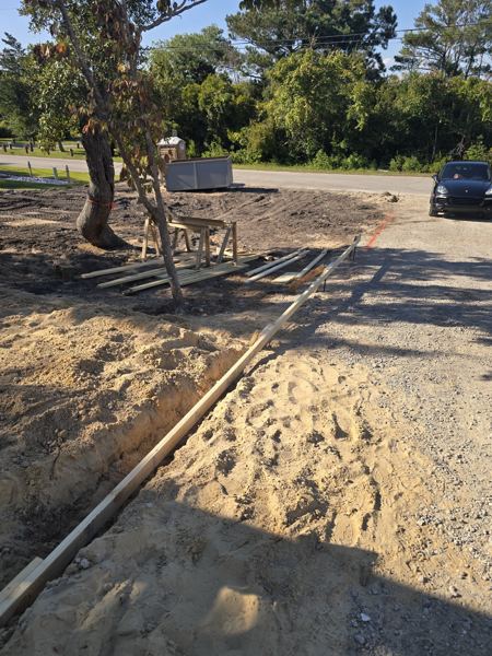Forms set for a concrete driveway along a gravel road