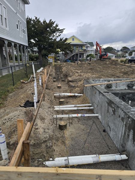 Block foundation and plumbing in place between coastal homes