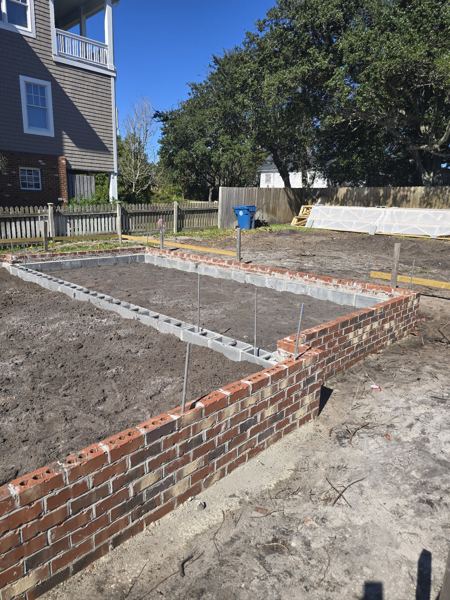 Brick foundation filled with sand ready for a slab