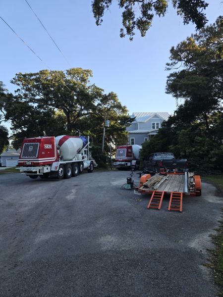 Ready-mix truck on a paved residential street at a job